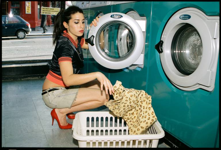 A red-stilettoed Winehouse transfers her laundry from a turquoise machine into a white hamper, like a scene out of some 1980s college movie. Photo / Diane Patrice