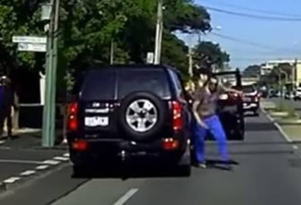 The enraged man gets out of his car to confront the cyclist. Photo / via YouTube
