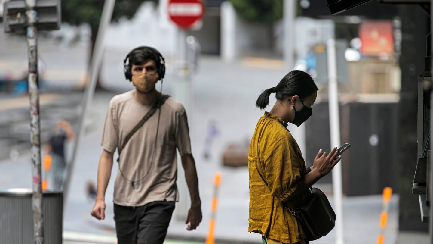 People wearing face masks in Auckland's central city. Photo / Alex Burton