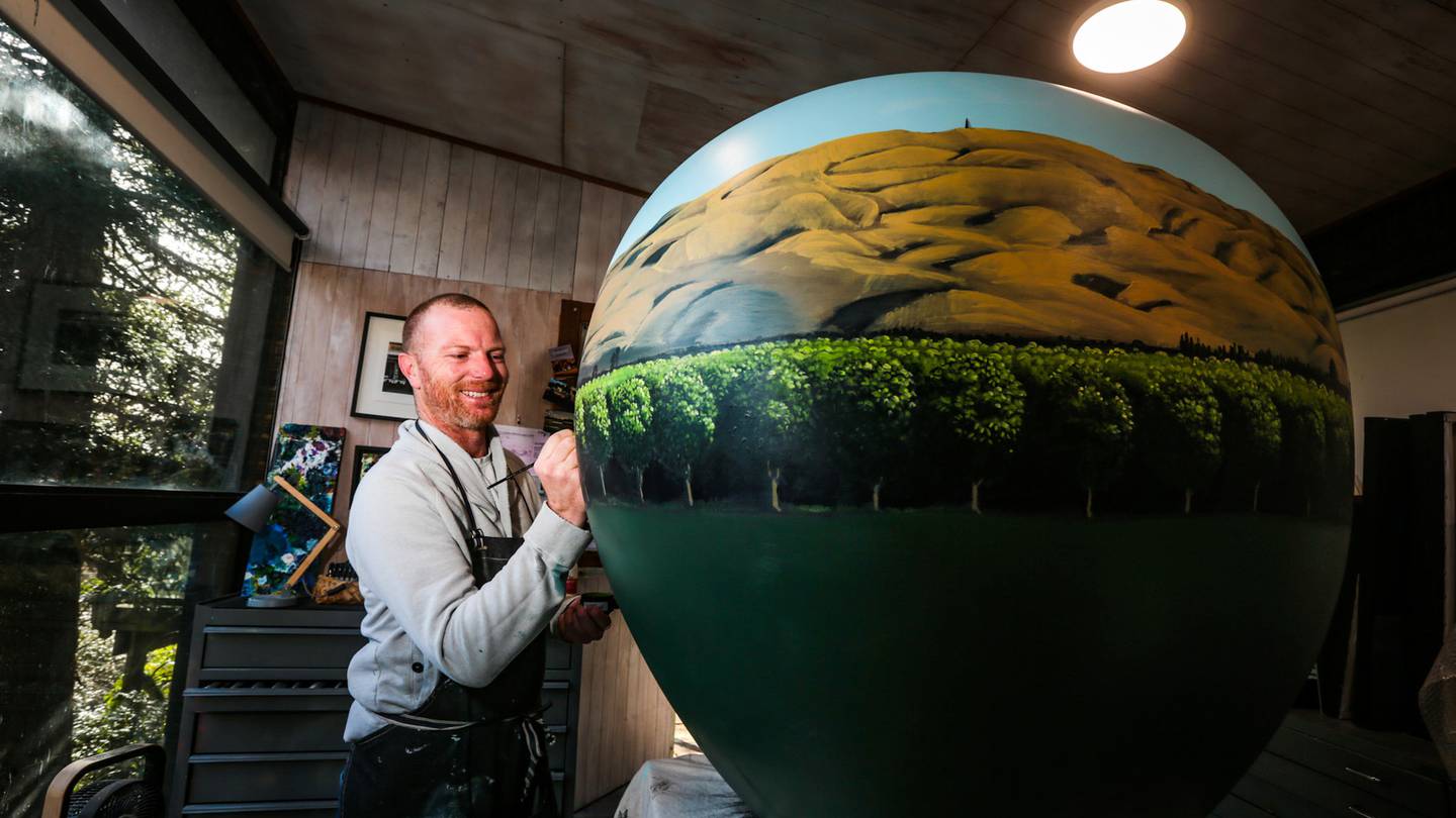 Havelock Artist Josh Lancaster working on his big apple for the Hawke's Bay Big Apple Project. Photo / Paul Taylor