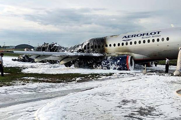 The Sukhoi Superjet 100 aircraft of Aeroflot Airlines is covered in fire retardant foam after an emergency landing in Sheremetyevo airport in Moscow, Russia.