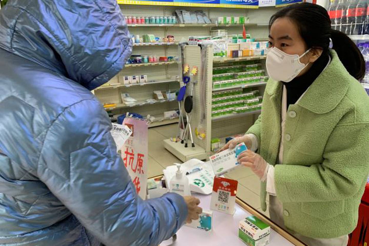 Pharmacist prepares medication for a customer at a pharmacy in Beijing. China's National Health Commission scaled down its daily Covid-19 report, in response to a sharp decline in PCR testing since the government eased antivirus measures after daily cases hit record highs. Photo / AP