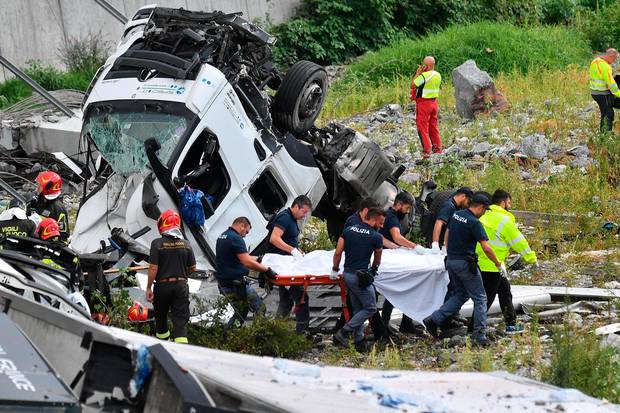 Rescuers recover victims of the collapse of the Morandi highway bridge, in Genoa, northern Italy. Photo / AP