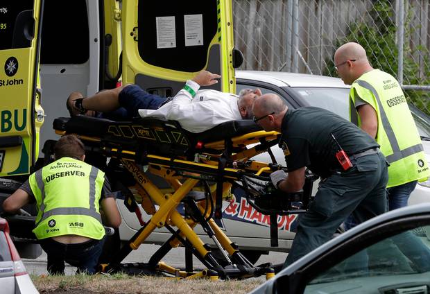 Ambulance staff tend to a man from outside a mosque in central Christchurch. Photo / AP
