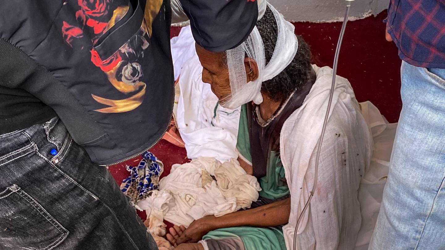 An elderly woman who fled to Axum in the Tigray region of Ethiopia to seek safety sits with her head bandaged after being wounded during an attack on the city. Photo / AP