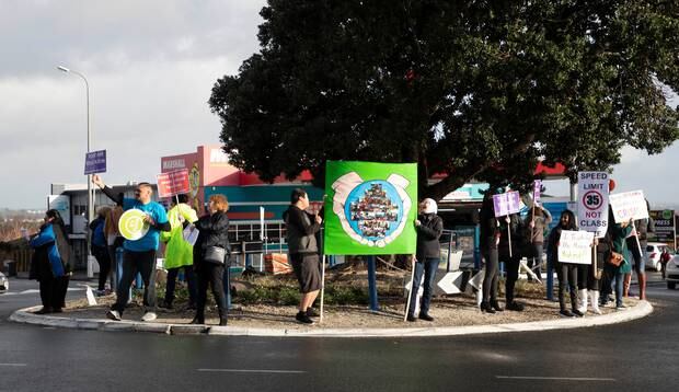 Some of the striking primary school teachers protest at the Blockhouse Bay shops this morning. Photo / Brett Phibbs