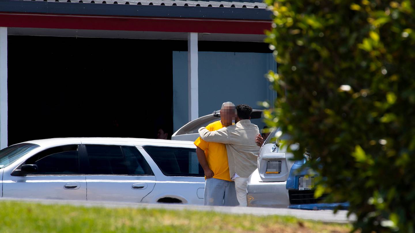 People could be seen hugging outside the Te Atatu church where emergency services responded to a serious incident. Photo / Hayden Woodward