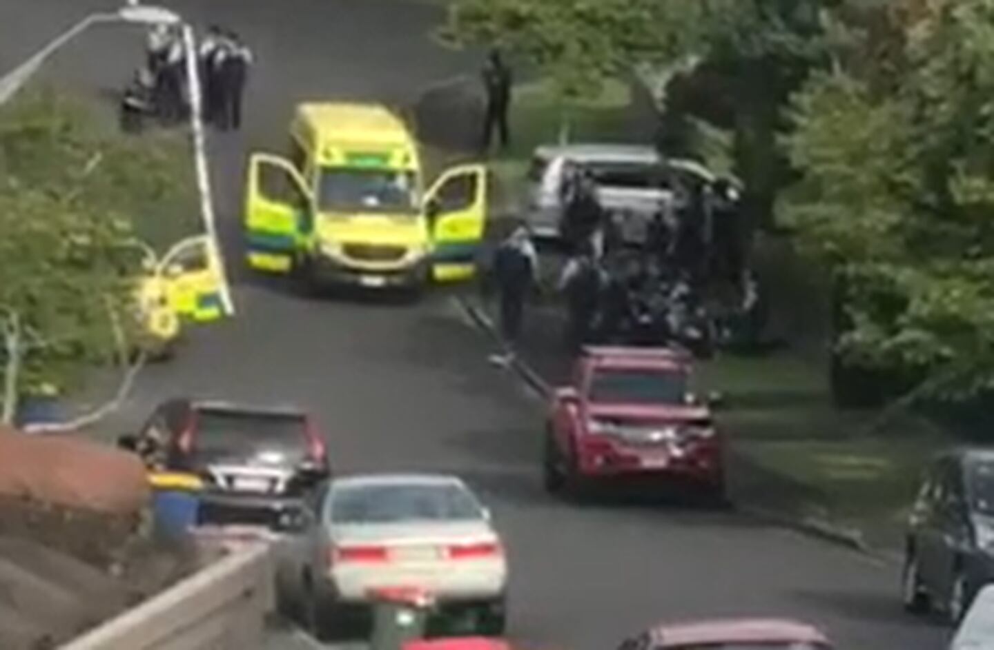 Footage filmed by a neighbour shows a person, believed to be a police officer, being treated by ambulance staff.