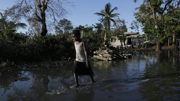 A young girl walks through flood waters near Beira, Mozambique. Much of the city is below sea level on one of the world's most vulnerable coastlines. Photo / Themba Hadebe 