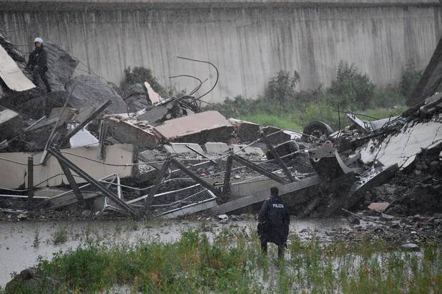 Rescues work among the debris of the collapsed Morandi motorway bridge in Genoa. Photo / AP