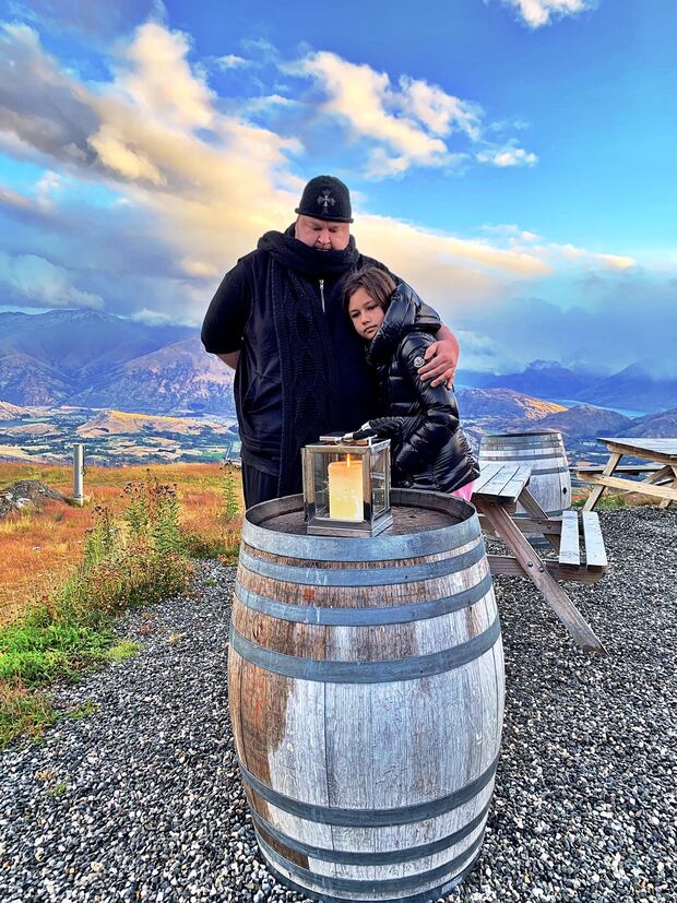 Kim Dotcom with eldest child Kaylo lighting a candle for her uncle Auji Auxtero, 18, who is believed to have taken his own life. Photo / Supplied