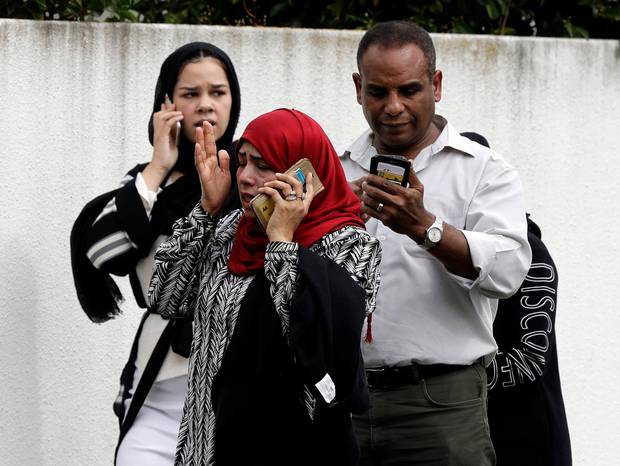 People wait outside a mosque in central Christchurch. Photo / AP