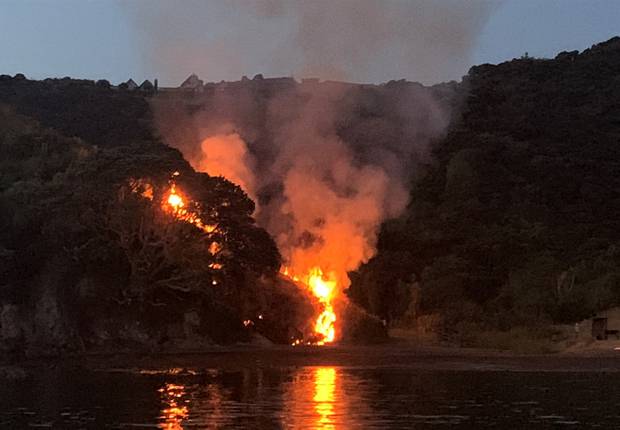 Flames race up the hillside towards Rangihoua Pā after the explosion. Photo / Vanessa Owen
