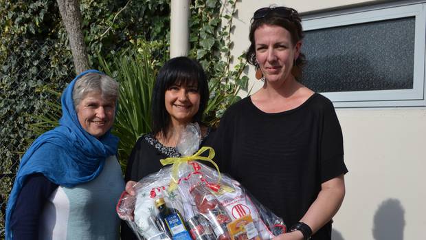 Sarah Hird, Queralt Scott and Cat Sleyer with a paella kit donated by Ambrosia.