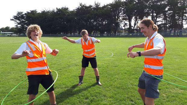 Whanganui High School prefects Cameron Russell, Thomas Friedel and Jack Clifton (all 17) have a bit of fun with the hula hoops in-between obstacle course races. Photo / Jesse King 