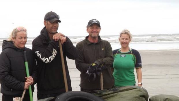 Kylie Coleman (left) and three of the other seven volunteers who worked together to pick up dead rats that washed up on a West Coast beach. Photo / Supplied, Kylie Coleman 