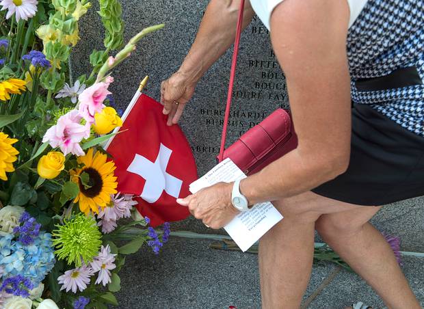 A Swiss flag is placed during a service at the Swissair Flight 111 memorial at Bayswater Beach on September 2 this year. Twenty years ago the passenger jet crashed in the Atlantic Ocean. Photo / AP
