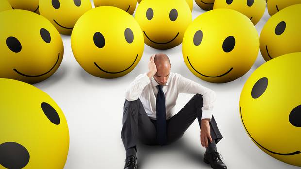 Downbeat businesspeople are surrounded by more optimistic consumers. Picture, 123RF