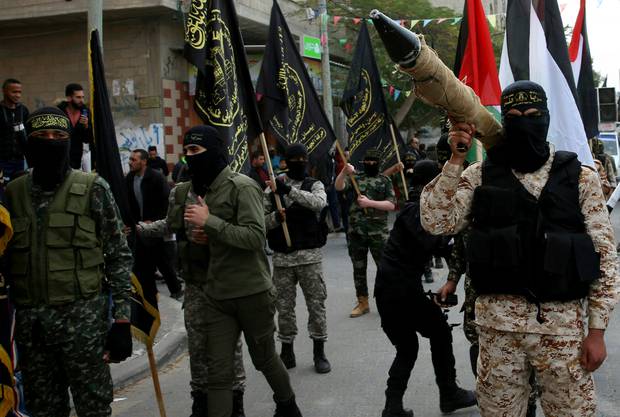 Palestinian Al-Quds Brigades, the military wing of the Islamic Jihad group, march with their rifles during a protest against President Trump. Photo / AP