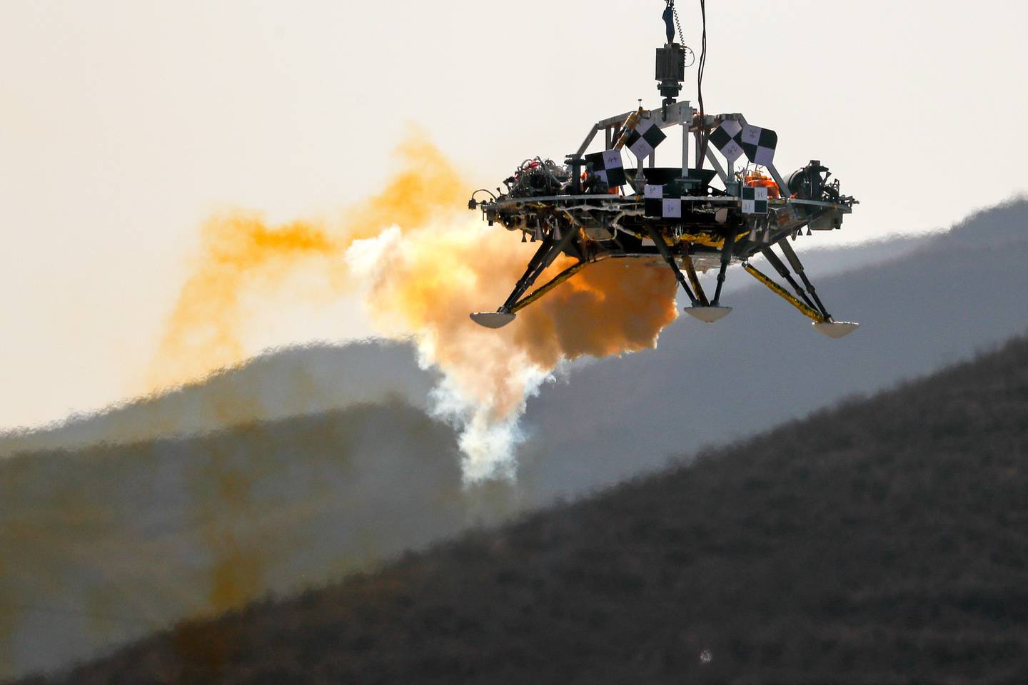 A lander is lifted during a test of hovering, obstacle avoidance and deceleration capabilities of a Mars lander in mid November 2019 at a facility in Huailai in China's Hebei province. Photo / AP