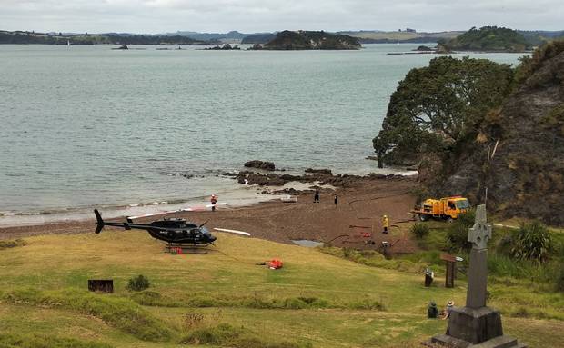 A Salt Air helicopter from Paihia and a Rural Fire appliance from Kaikohe at Rangihoua Bay the following morning, with Marsden Cross on the right. Photo / Supplied