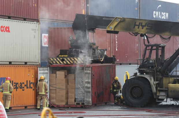 The reach stacker is still attached to a container. Photo / Brett Phibbs
