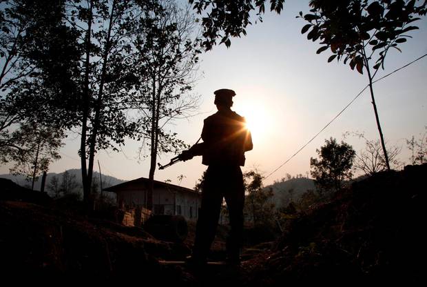 A Kachin Independence army rebel stands at frontline outpost facing no man's land in Lawa Yang, in northern Kachin state, Myanmar. Photo / AP