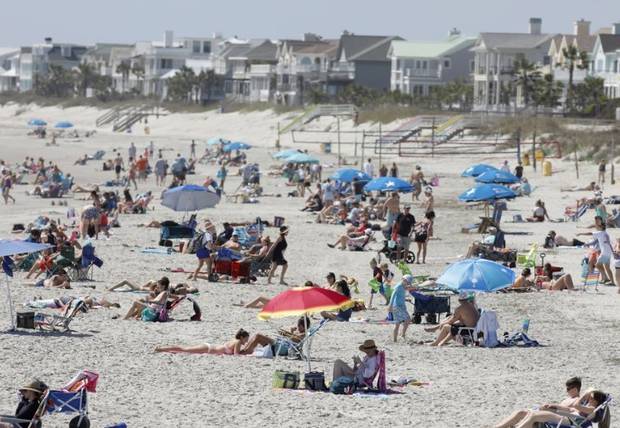Despite warnings from government officials take caution and self-distance because of coronavirus, beachgoers enjoy the Isle of Palms Beach in South Carolina.