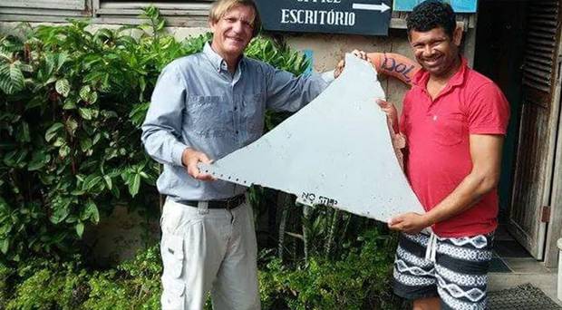 Blaine Gibson and a local investigator hold up the famous 'No Step' fragment. Photo / Blaine Alan Gibson / Facebook / Supplied 