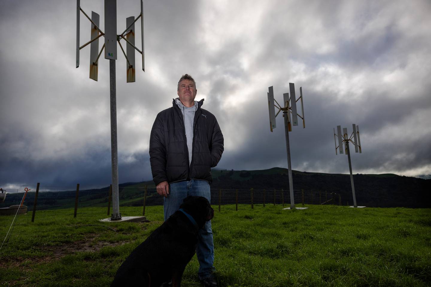 Te Miro farmer Marcel Hannon beside derelict wind turbines that never produced the power required for his new home. Photo / Mike Scott 