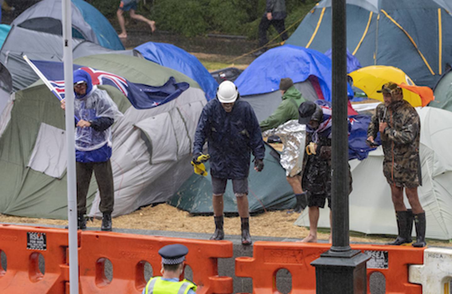 Protesters braving wet conditions during the anti-vax, anti-mandate and anti-Government protest and occupation at Parliament in Wellington. 13 February, 2022. Photo / Mark Mitchell