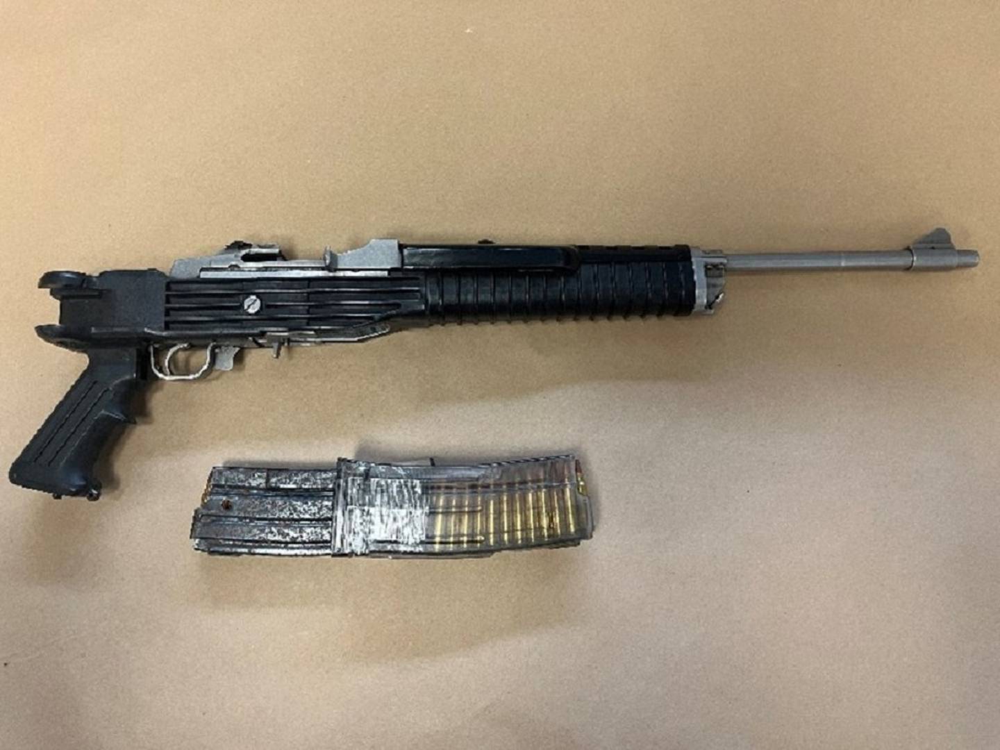 Police found an AK-47-style semi-automatic rifle and two magazines taped together in Brandon Tangi's car. 