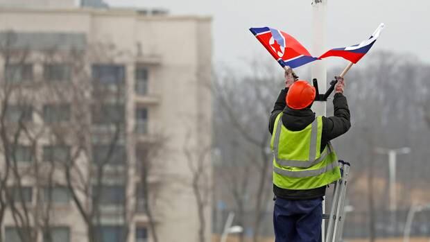 A worker adjusts the flag of Russia and North Korea along the road in Russky Island, off the southern tip of Vladivostok. Photo / AP