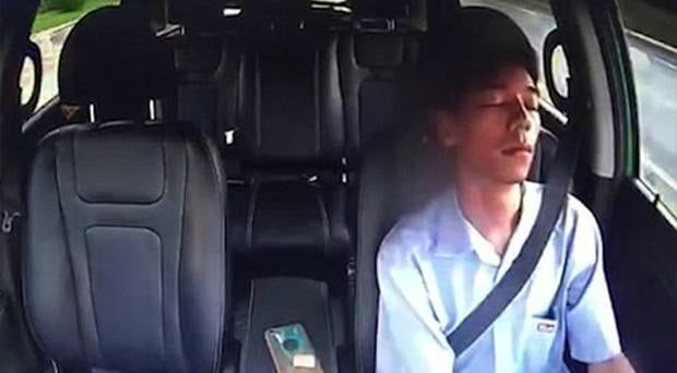 This is the frightening moment a taxi driver fell asleep at the wheel before crashing into the barriers. Photo / Newsflare