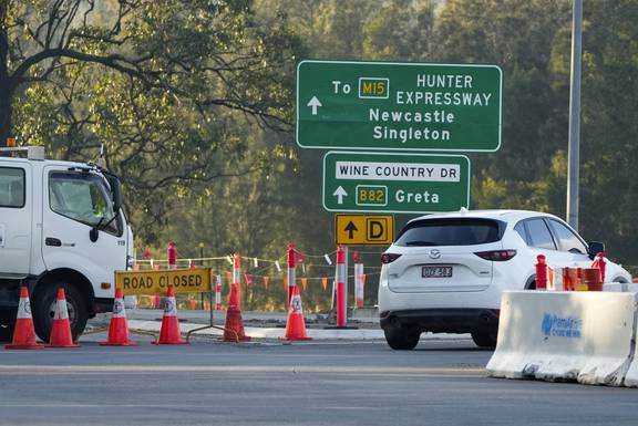 A roadblock is set up near the town of Greta following a bus crash in the Hunter Valley, north of Sydney. Photo / AP