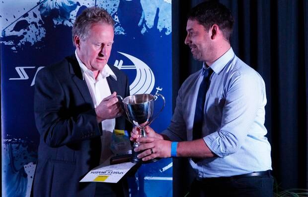 Andrew Spence, left, collects his Coach of the Year award.