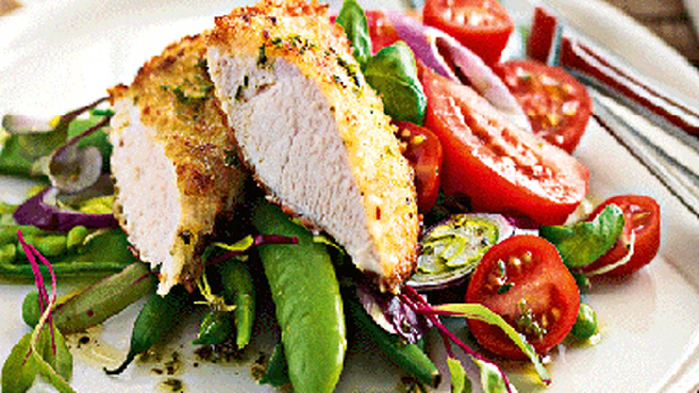 Pesto and parmesan chicken schnitzel with tomato and bean salad - NZ Herald