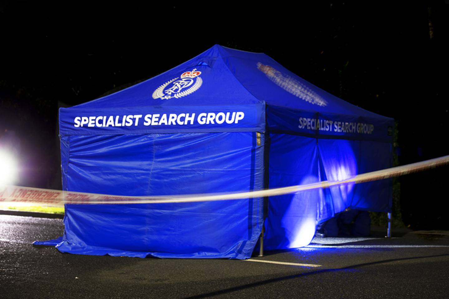 A tent is erected outside a property where a woman was fatally shot in Henderson last night. Photo / Hayden Woodward