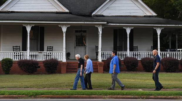 Jimmy and Rosalynn Carter walk home with Secret Service agents. Photo / Washington Post / Matt McClain