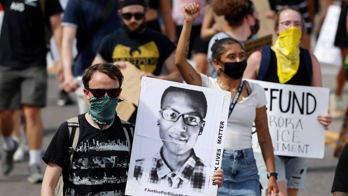 A protester carries an image of Elijah McClain during a rally in Aurora, in 2020. A Colorado judge last week responded to a request to release an amended autopsy report of McClain's death. Photo / AP