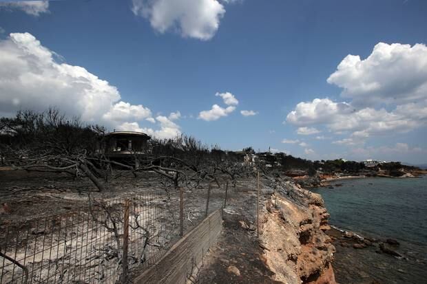 A burned compound is seen next to the sea in Mati, east of Athens. Photo / AP