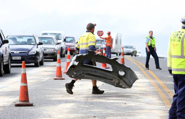 Part of a vehicle being removed from the road after a serious crash on Smeaton's Hill, Northland, 2016.