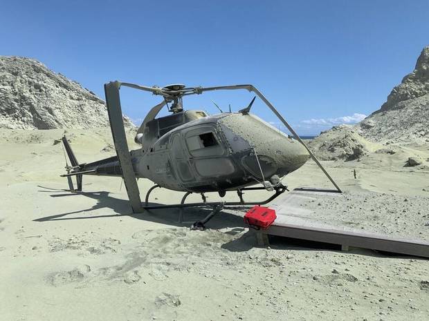 Damaged helicopter is seen on White Island after the deadly eruption. Photo / Instagram