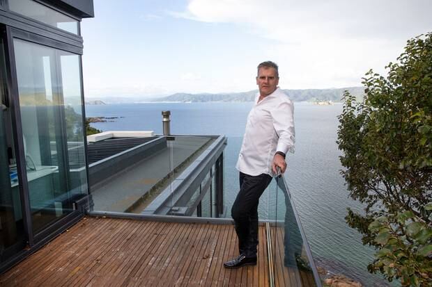 Matthew Ryan on the deck of his house in Karaka Bay, Wellington, which he rented to a foreign diplomat. He is owed unpaid rent. Photo / Mark Mitchell 