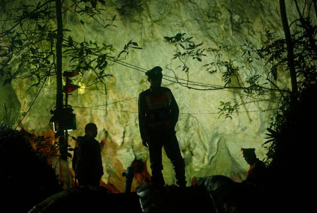 Thai police stand in front of the entrance to the cave complex. Photo / AP