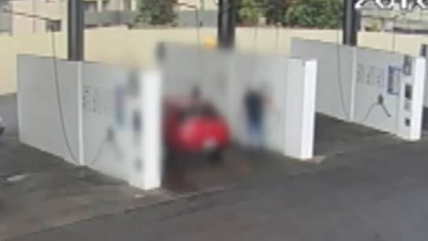 The accused is seen washing a rental car. Photo / Supplied