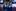 Актриса Юлия Пересильд (слева), кинорежиссер Клим Шипенко (справа) и космонавт Антон Шкаплеров машут руками из автобуса перед стартом.  Изображение/Роскосмос через AP
