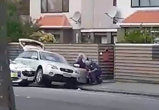 Still from video showing the moment police arrest a man after ramming his car off the road. Photo / Supplied