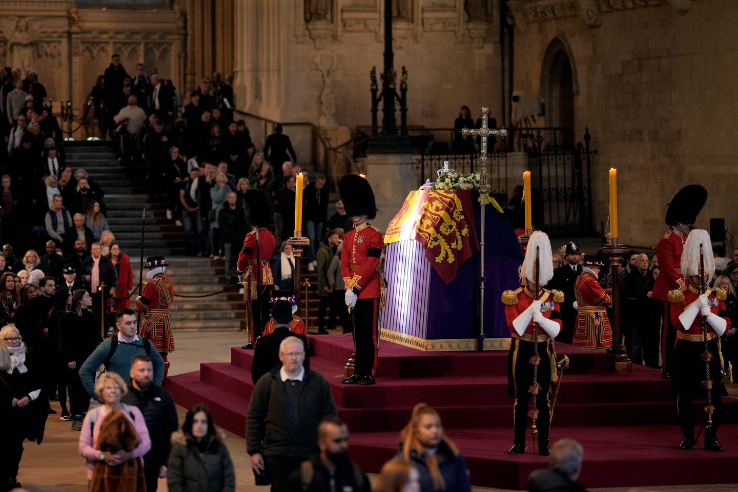 A ray of sun shines on the coffin as members of the public file past the coffin of Queen Elizabeth II. Photo / AP