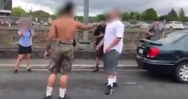 The shirtless can be seen holding a machete to the other student's throat. Photo / Facebook